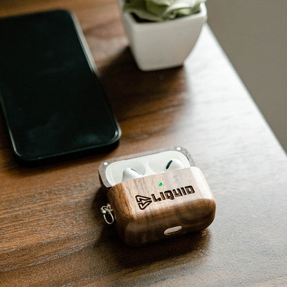 Branded Walnut AirPods Case on desk with Airpods inside