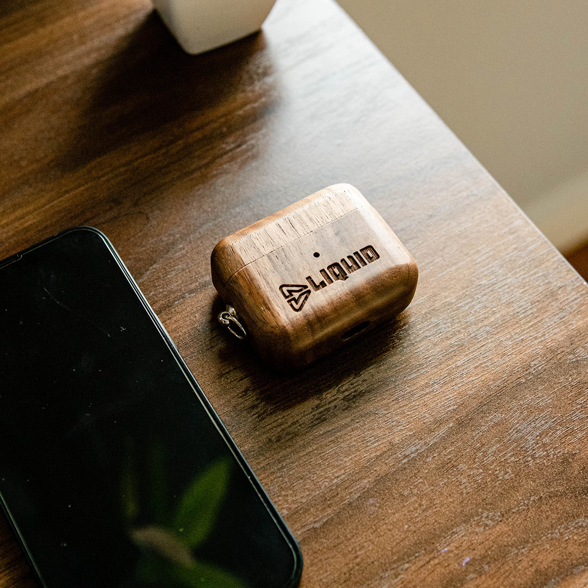 Branded Walnut AirPods Case on desk